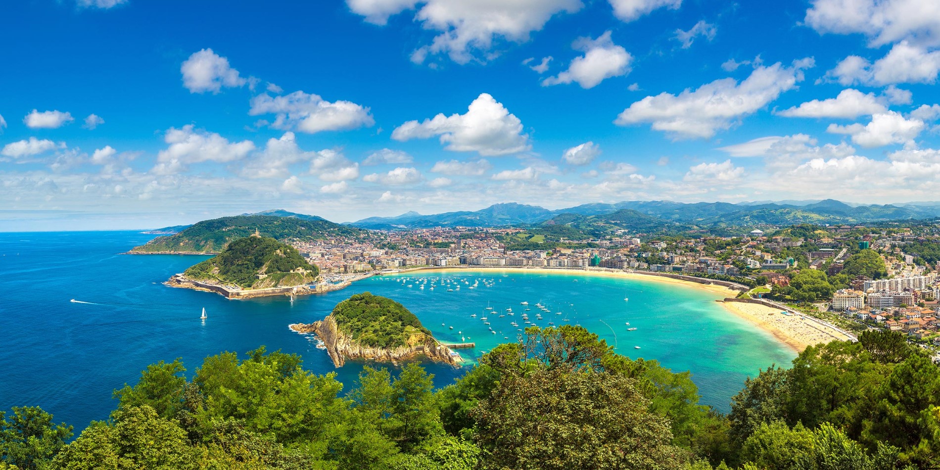 Beach Playa de la Concha in San Sebastian, Spain, from above. A bay with sandy beach and turquoise water.